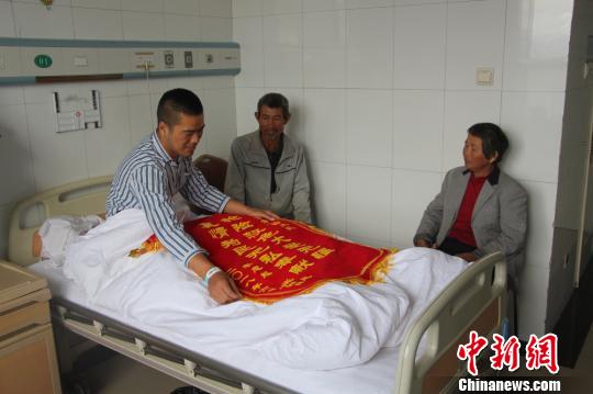 被救的李忠起、張總鳳夫婦看望受傷后的李運(yùn)飛?！⊥粲?攝