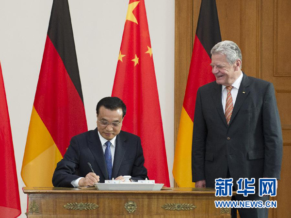 10月10日，國務(wù)院總理李克強在柏林會見德國總統(tǒng)高克。這是李克強總理在高克總統(tǒng)的陪同下在貴賓簿上簽字。 新華社記者 王曄 攝 